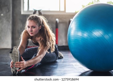 Cinematic tone of young attractive fitness woman exercise with ball in gym. Individual sport to fit muscles of body for healthy life concept. 