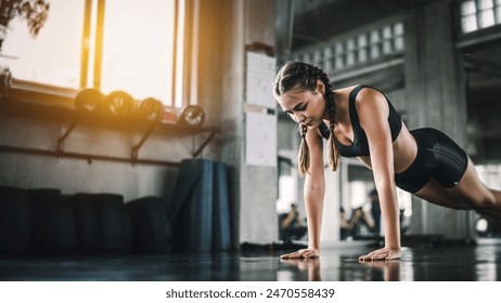 Cinematic tone of young attractive fitness woman exercise with machine in gym. Individual sport to fit muscles of body for healthy life concept. - Powered by Shutterstock