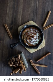 Cinnamon Bun With Icing Baked In A Cast Iron Skillet.