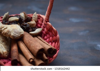 Cinnamon, ginger and raisins in basket on wooden background. Ingredients for mulled wine. Rustic still life. - Shutterstock ID 1318162442