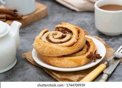 Cinnamon roll bun close up. Cinnamon swirl pastry for breakfast.