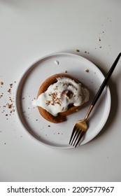 Cinnamon Roll With Mascarpone Cream On Plate, Appetizing Homemade Pastries, Sweet Baking Bun, Dessert Close Up, White Background, Top View, Flat Lay