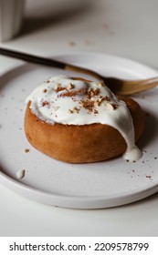 Cinnamon Roll With Mascarpone Cream On Plate, Appetizing Homemade Pastries, Sweet Baking Bun, Dessert Close Up, White Background, Flat Lay