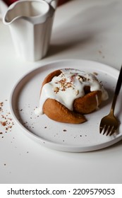 Cinnamon Roll With Mascarpone Cream On Plate, Appetizing Homemade Pastries, Sweet Baking Bun, Dessert Close Up, White Background, Flat Lay