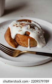 Cinnamon Roll With Mascarpone Cream On Plate, Appetizing Homemade Pastries, Sweet Baking Bun, Dessert Close Up, White Background, Flat Lay