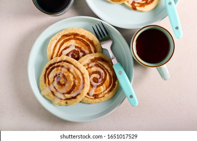Cinnamon roll pancakes served on plate