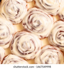 Cinnamon Roll. Rolls And Cream Sauce. Full Baking Tray With Buns With Cheese Sauce. Cinnabon Bun, Swirl, Snail  With Glaze