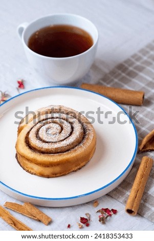 Cinnamon roll served on a ceramic plate