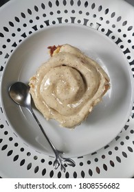 Cinnamon Roll With Tiramisu Glaze On The White Plate. Angle Flat Lay. Selected Focus. 