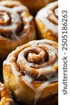  cinnamon rolls arranged in an enticing layout. The cinnamon rolls are golden-brown with swirls of cinnamon and sugar, topped with a generous drizzle of creamy icing.