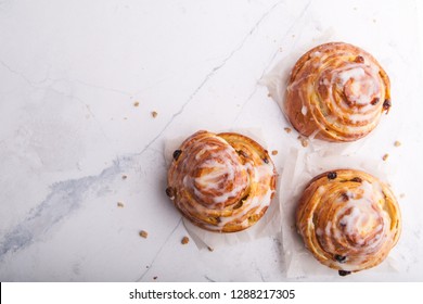 Cinnamon Rolls Buns On A White Marble Background. Bakery Concept. Breakfast And Brunch. Flatlay. Overhead. Copy Space