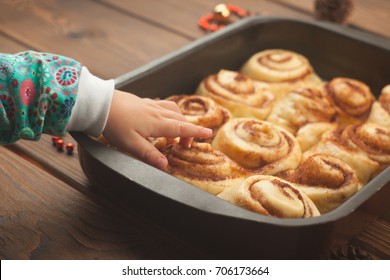 cinnamon rolls or cinnabon handmade raw dough preparation with spices and cocoa and children hands - Swedish Christmas Food cinnamon rolls or cinnabon handmade raw dough preparation with spices and cocoa and children hands - Swedish Christmas Food