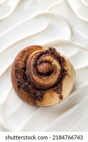 Cinnamon Sinnabon Bun, With Vanilla Fudge On A White Cream Background.