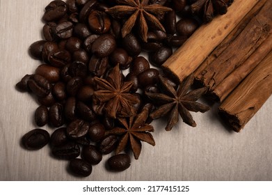 Cinnamon, Star Anise, Coffee Beans Up Close On A Light Wood Background Shot From Above