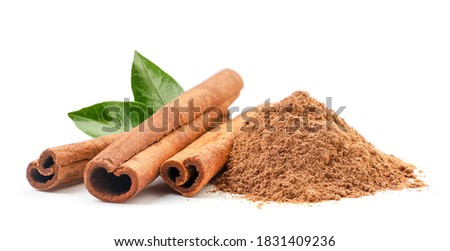 Cinnamon sticks and ground with fresh leaves on a white background. Isolated