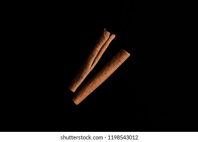 Cinnamon Sticks isolated on black wooden background  - Shutterstock ID 1198543012