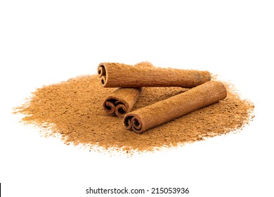 Cinnamon sticks lying on a bed of ground cinnamon - Shutterstock ID 215053936