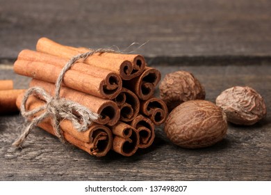 Cinnamon Sticks And Nutmeg On Wooden Table