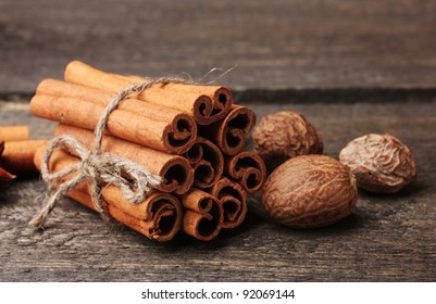 Cinnamon Sticks And Nutmeg On Wooden Table