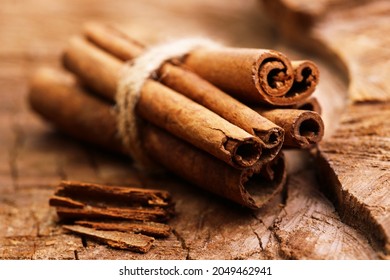 Cinnamon sticks on a wooden background - Shutterstock ID 2049462941