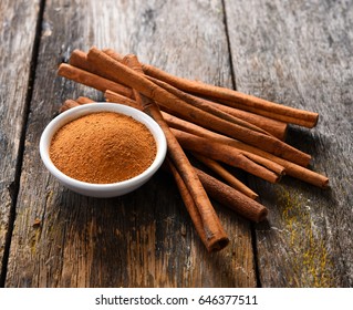Cinnamon sticks and cinnamon powder on wood - Shutterstock ID 646377511
