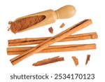 Cinnamon sticks with powder in wooden scoop isolated on white background with full depth of field. Top view. Flat lay.