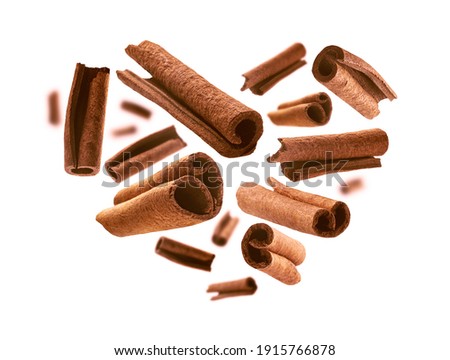 Cinnamon sticks in the shape of a heart on a white background