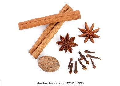 Cinnamon sticks with star anise, nutmeg and clove isolated on white background. Top view