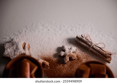 Cinnamon sticks and star-shaped cookies dusted with powdered sugar evoke festive warmth and coziness. - Powered by Shutterstock