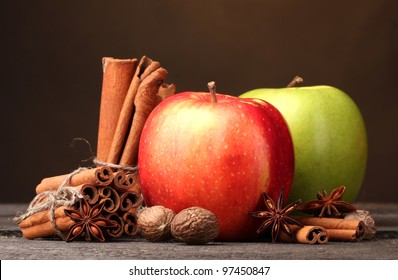 Cinnamon Sticks,apples Nutmeg And Anise On Wooden Table On Brown Background