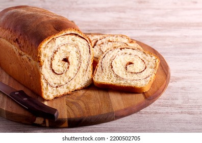 Cinnamon swirl bread, sliced on wooden board
