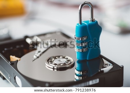 Cipher padlock on opened hard disk. Encrypted disk drive. Data security