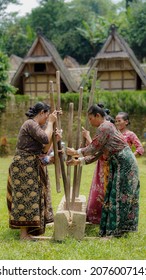 Cipta Mulya, Sukabumi  Indonesia - April 2020: Gegendek is a music created from the sound of halu beaten against lisung. Music can be produced 
when some women are pounding paddies into rice, beating