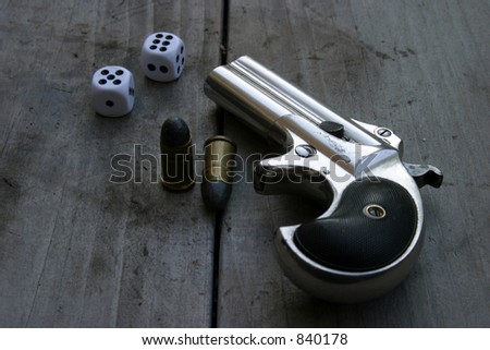 Circa 1889, Model 95, Type II Model 3 Double Derringer, on antique wooden table with shells and dice