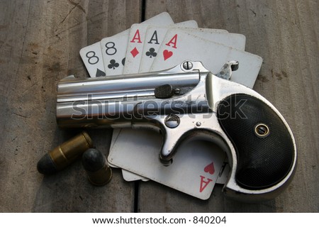 Circa 1889, Model 95, Type II Model 3 Double Derringer, on antique wooden table aces and eights aka a 