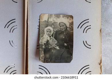 CIRCA 1942: Vintage photo of a Soviet woman with her child on a retro photo album page