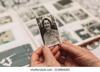 CIRCA 1970: Elderly woman holding vintage, black and white photo of her young self. Passing of time concept - Shutterstock ID 2118834365