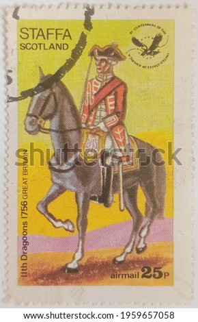 Circa 1976: A stamp printed in Cinderellas shows Uniform of the 11th Dragoons, Great Britain, Staffa Scotland.