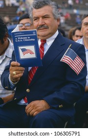 CIRCA 1990 - Latino American Man With U.S. Citizenship Book At Induction Ceremony In East Los Angeles, CA