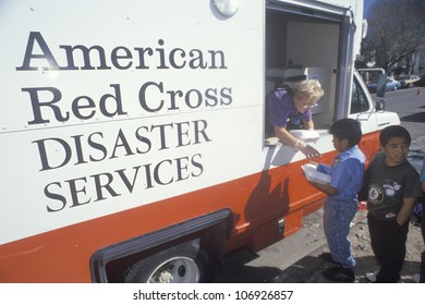 CIRCA 1994 - A Red Cross Worker Handing Out Meals From A Disaster Services Van