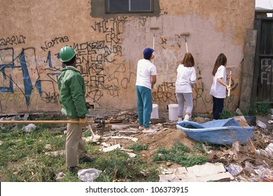 CIRCA 1999 - People Painting Over Graffiti On Apartment Building