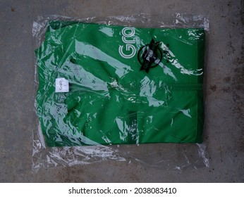 Circa August 2021, Seremban, Negeri Sembilan : Image Of Unboxing Grab Food Jacket In Plastic Wrap