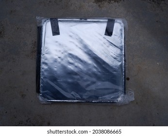 Circa August 2021, Seremban, Negeri Sembilan : Image Of Unboxing Grab Food Beg In Plastic Wrap