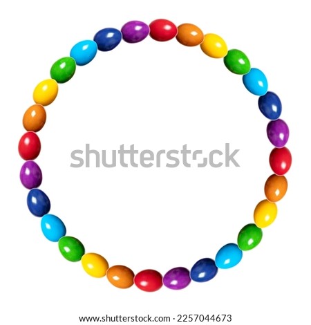 Circle border made of rainbow colored eggs. Circular frame, made of multi colored, dyed chicken eggs. Traditionally used during Easter time as gift or for decoration. Isolated, on white background.