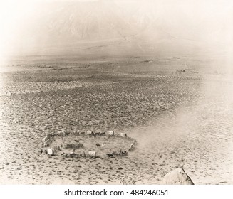 Circle of covered wagons on open plain
