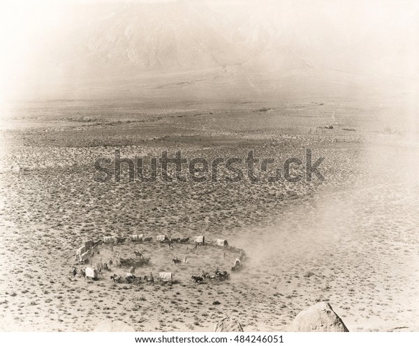 Circle of covered wagons\
on open plain