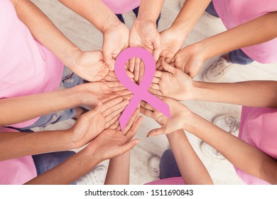 Circle Of Diverse Women Hands Holding Pink Breast Cancer Ribbon Standing Together Indoor. Oncology And Support. Top View - Shutterstock ID 1511690843