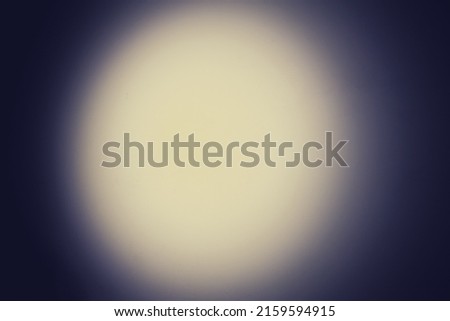 Circle of light from a night flashlight on a white wall, copy space