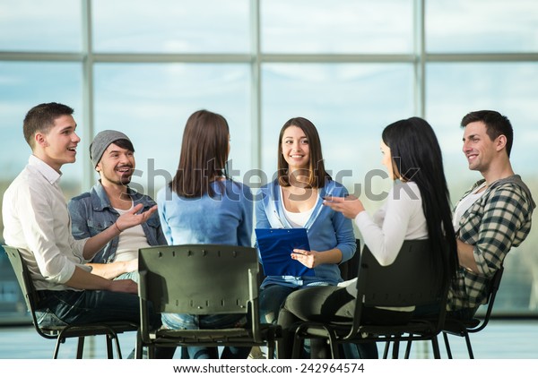 Circle of trust. Group of people are sitting in\
circle and supporting each\
other.