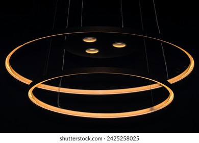 Circles and lights abstract hanging from a ceiling in the dark